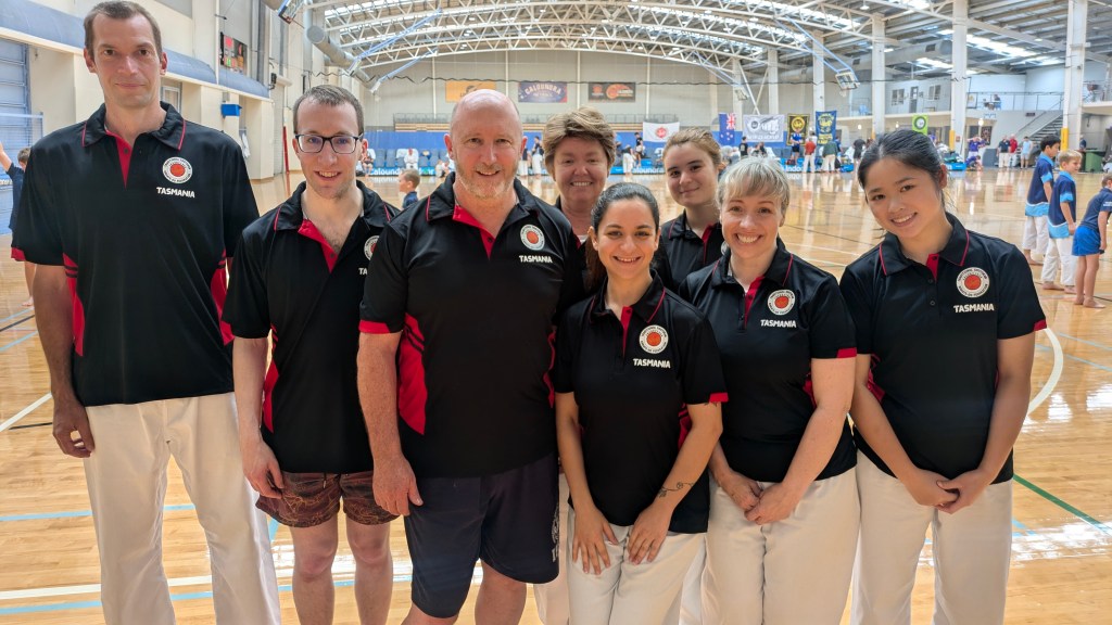 a group of people in matching polos that say TSKF Tasmania